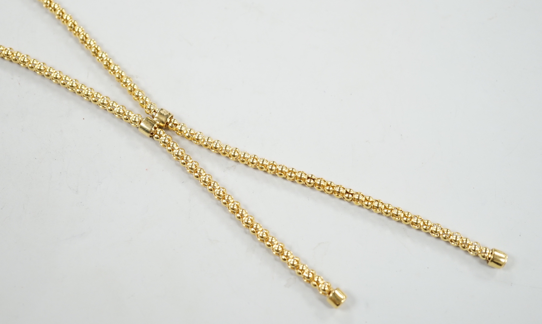 A modern 9ct gold graduated twin tassel necklace, 65cm, 15.7 grams.